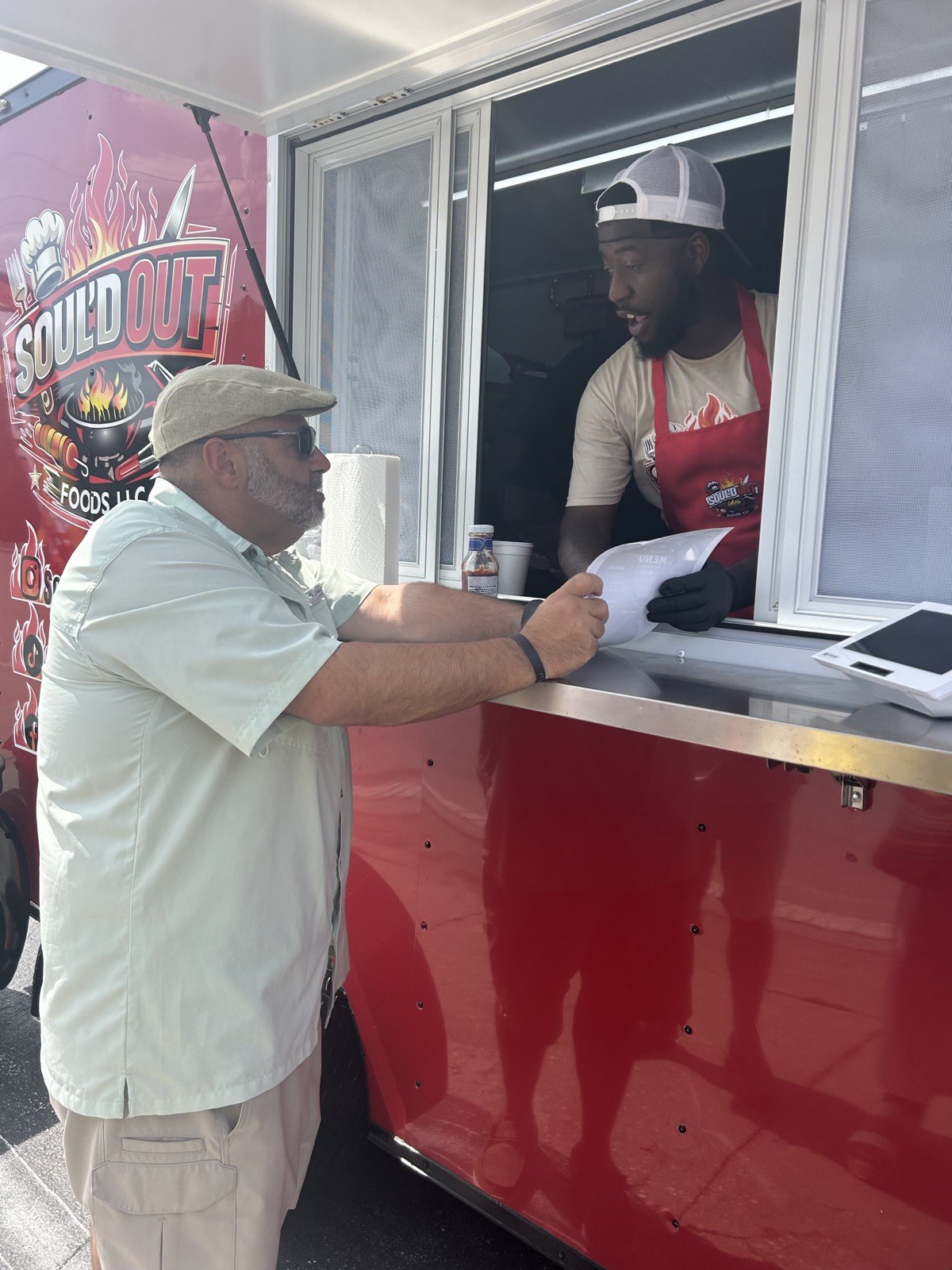 Customer ordering at the Soul'd Out Foods window