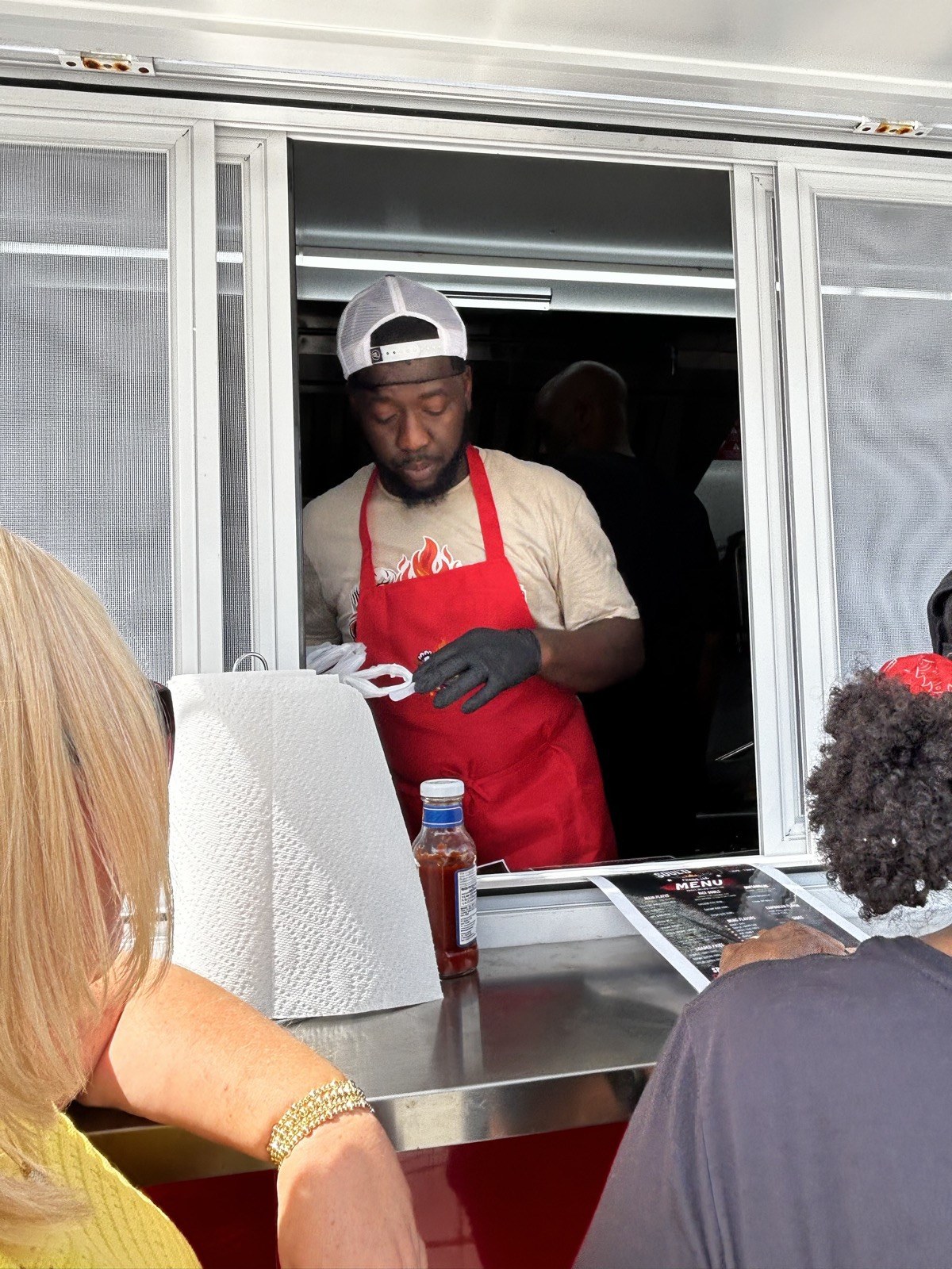 Chef Demarquis serving from the food trailer window